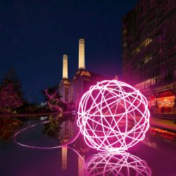 Spin Me a Yarn - a bright pink light installation representing a ball of wool, on display outside Battersea Power Station.