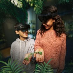 Two young visitors handling virtual reality frogs at the Visions of Nature exhibition at the Natural History Museum.