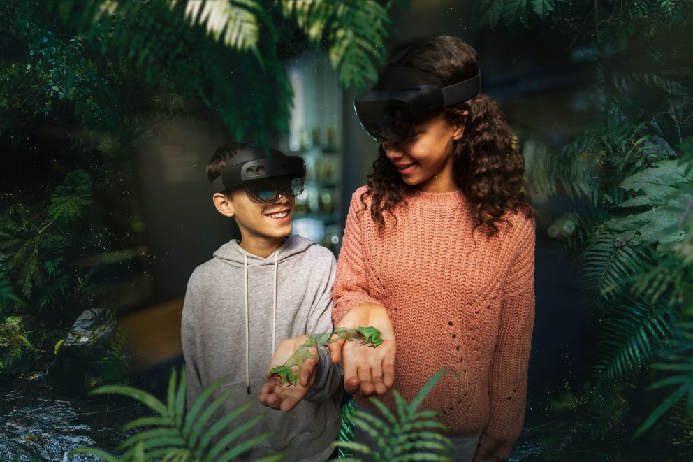 Two young visitors handling virtual reality frogs at the Visions of Nature exhibition at the Natural History Museum.