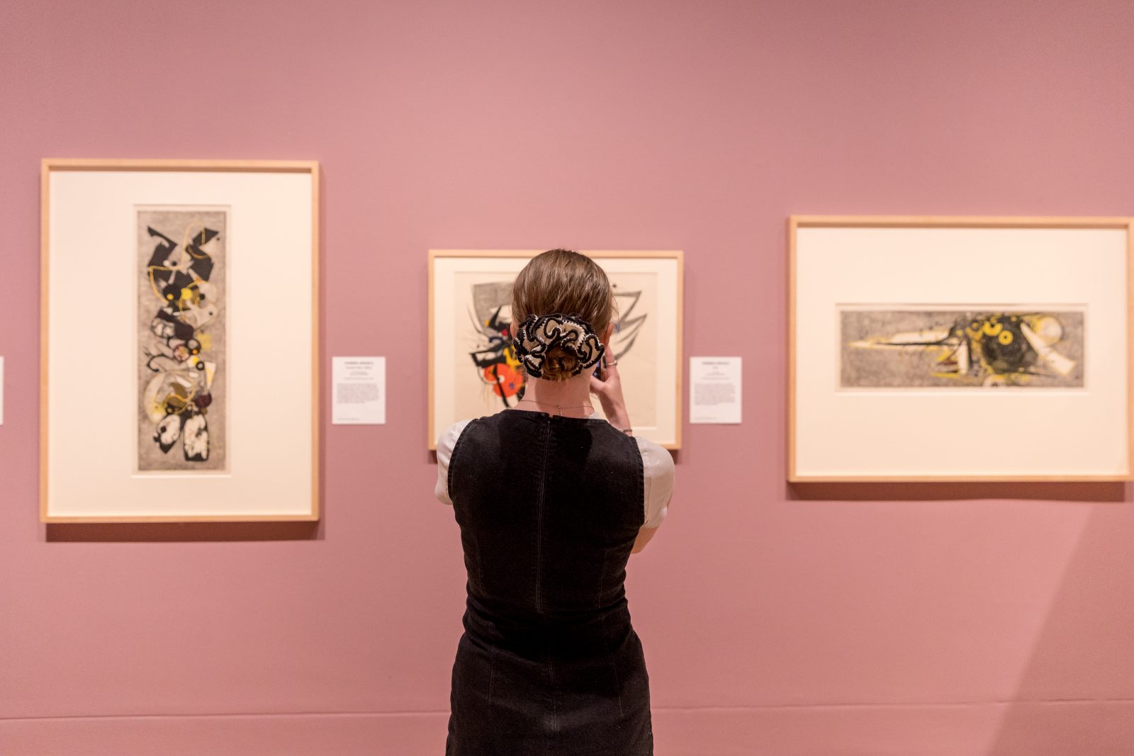 A visitor looking at Yoshida: Three Generations of Japanese Printmaking exhibition artworks at the Dulwich Picture Gallery.